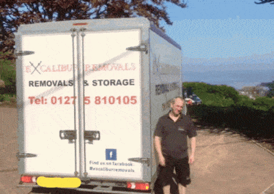 man standing beside a removals van